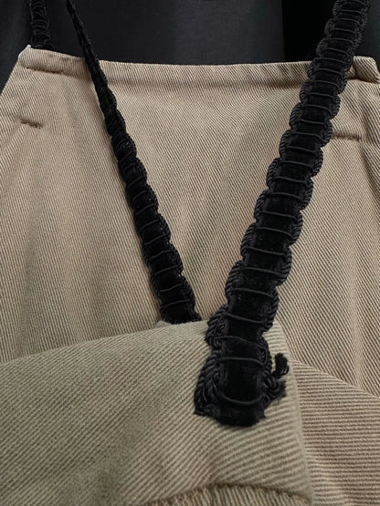 beige velvet overalls with silver buckles