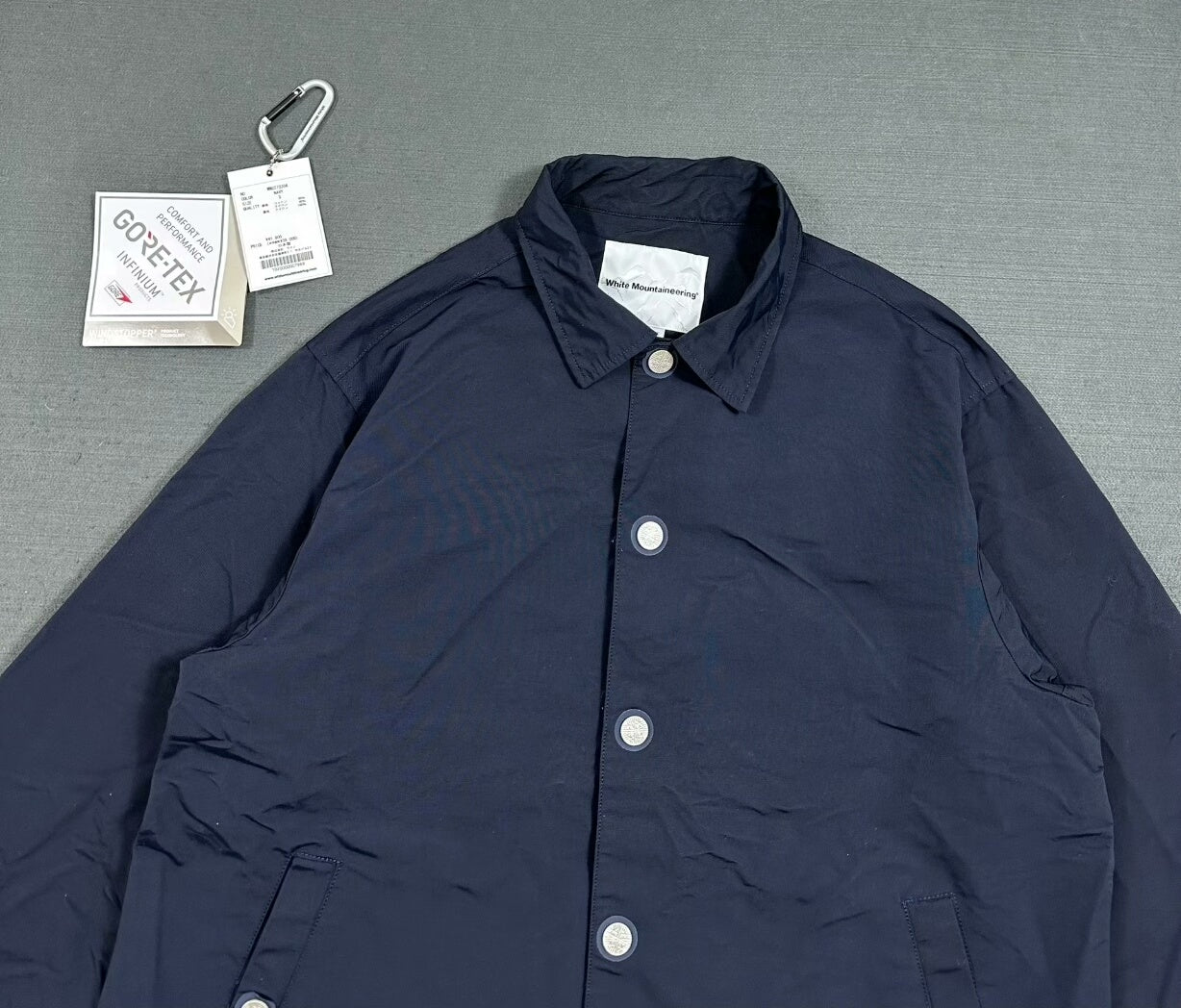white mountaineering gore-tex coach jacket