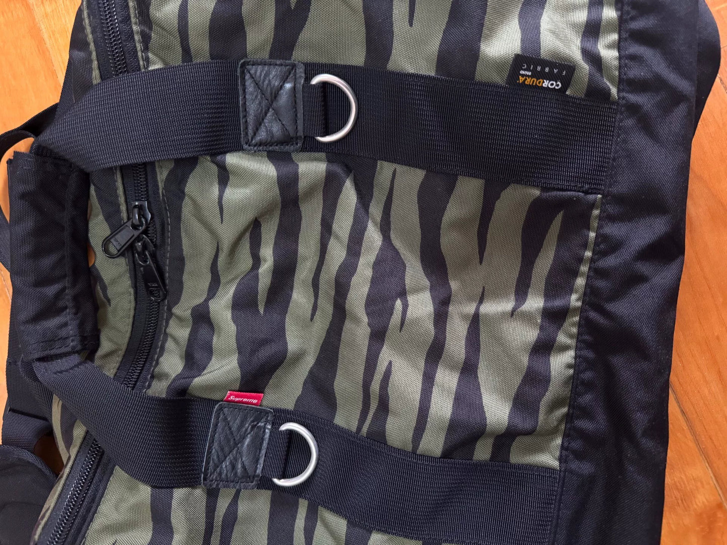 supreme camouflage duffle bag with red tag