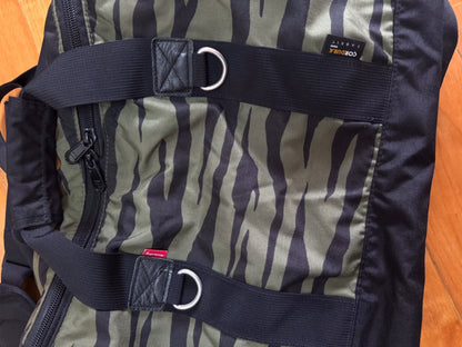 supreme camouflage duffle bag with red tag