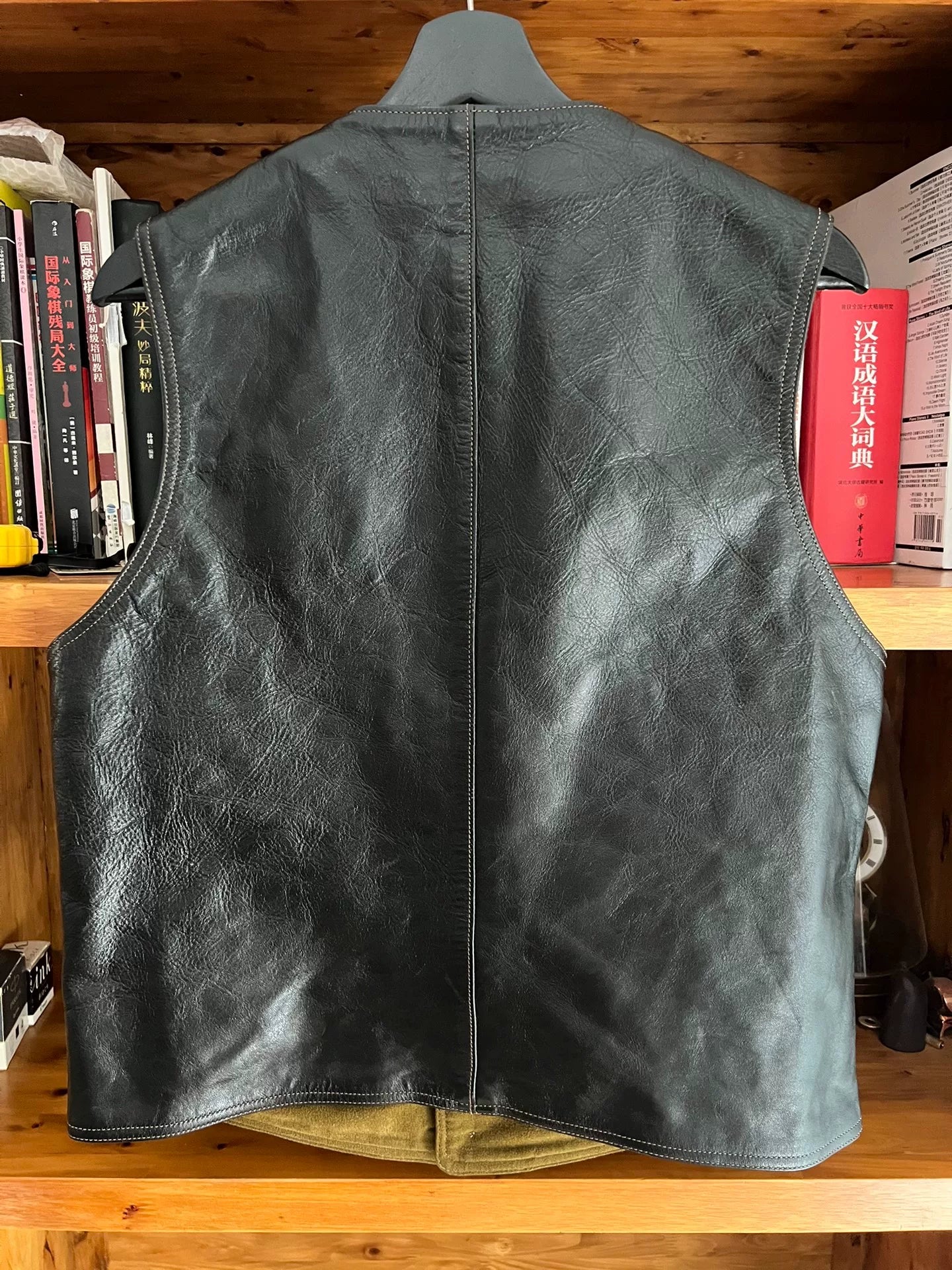 black leather vest with military green lining