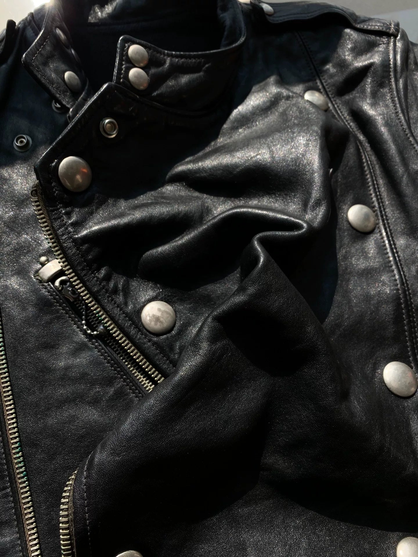 black leather biker jacket with detailed embellishments