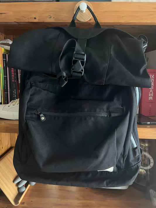 black roll-top backpack with multifunctional pockets