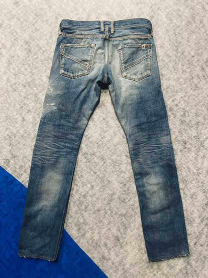 distressed low-rise blue denim jeans