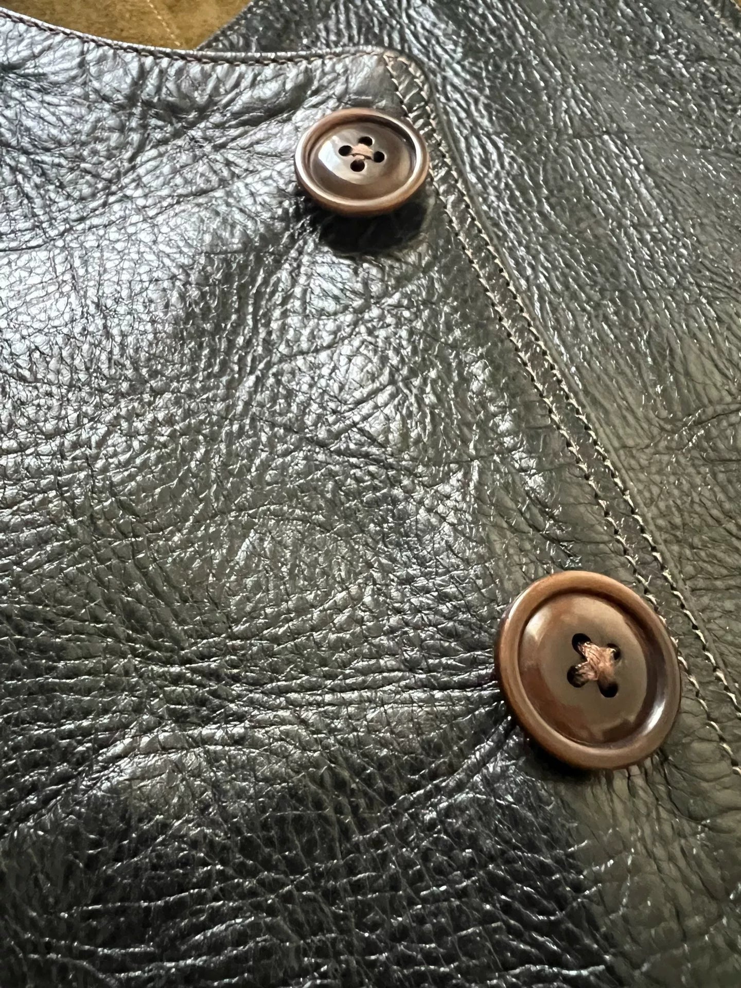 black leather vest with military green lining