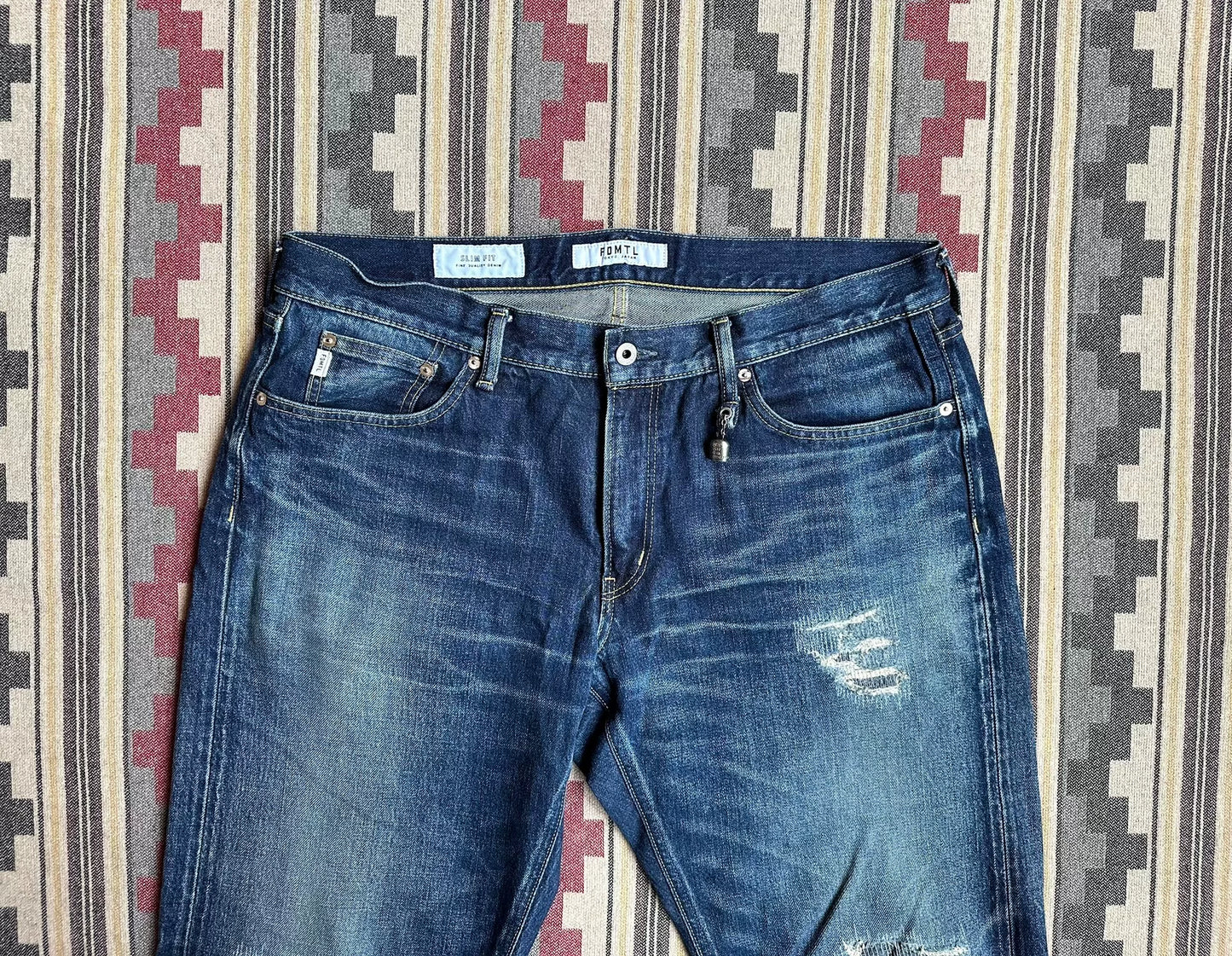fdmtl slim fit denim with repair patches