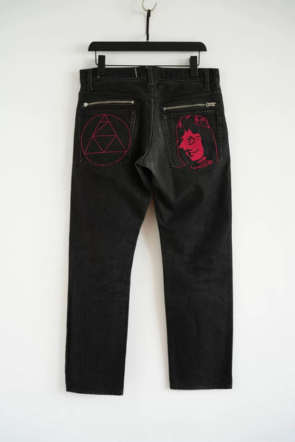 embroidered black denim pants by Undercover