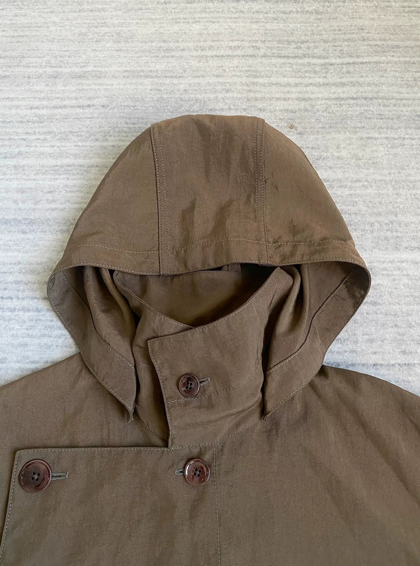 brown belted trench coat with military silhouette