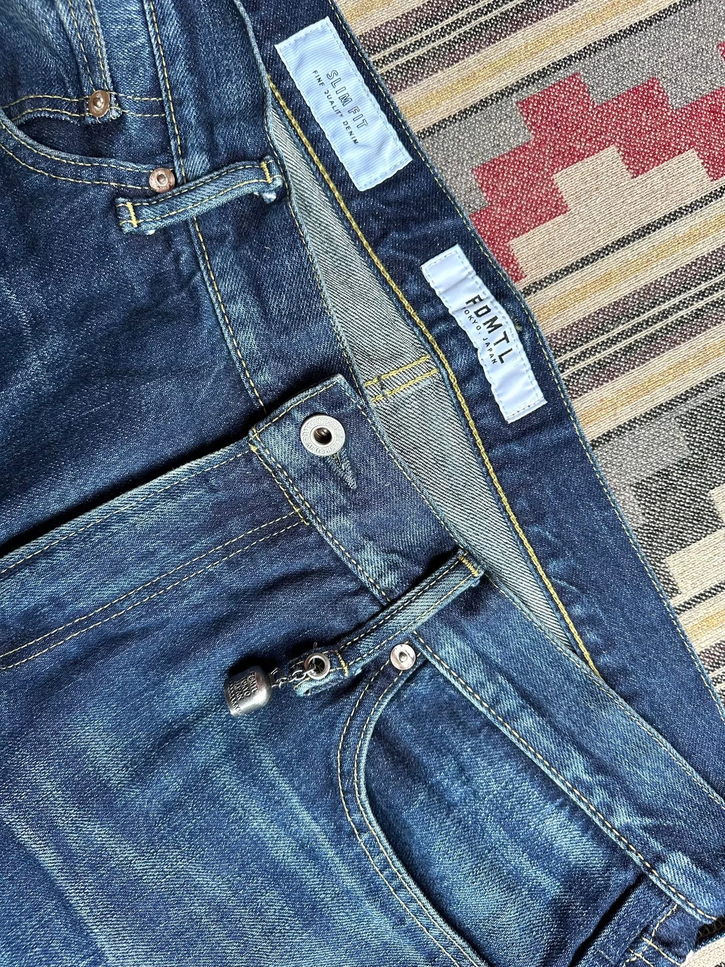 fdmtl slim fit denim with repair patches