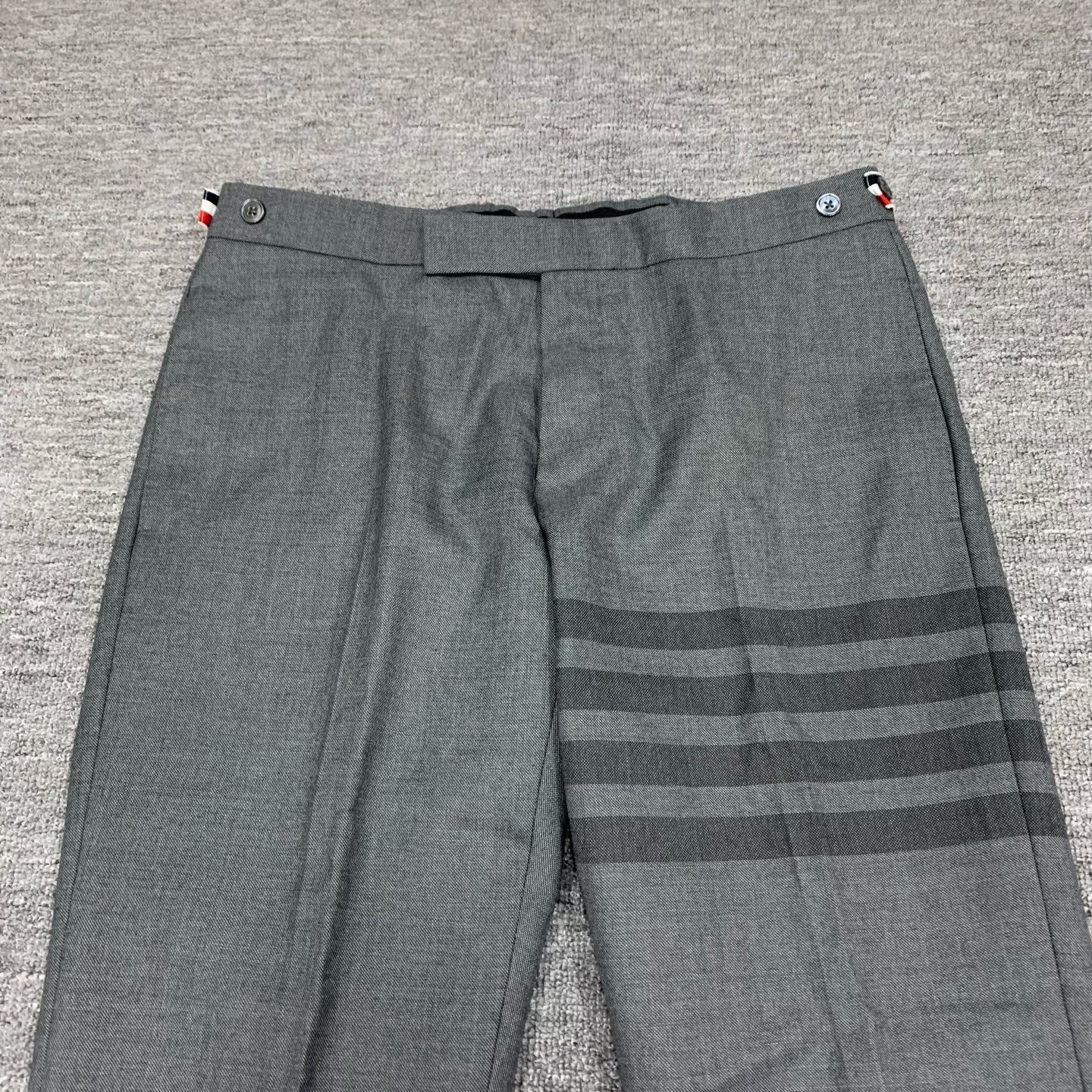 gray striped wool suit trousers by Thom Browne