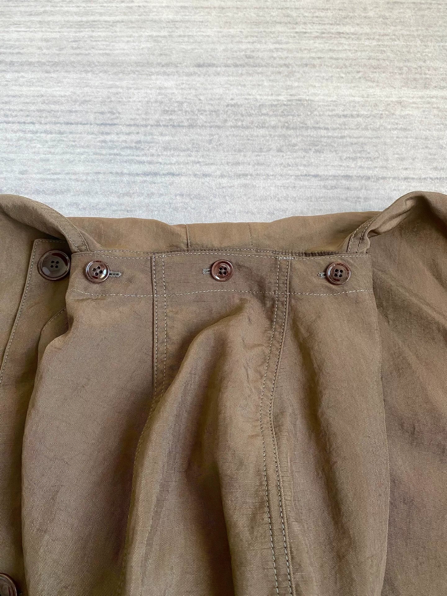 brown belted trench coat with military silhouette