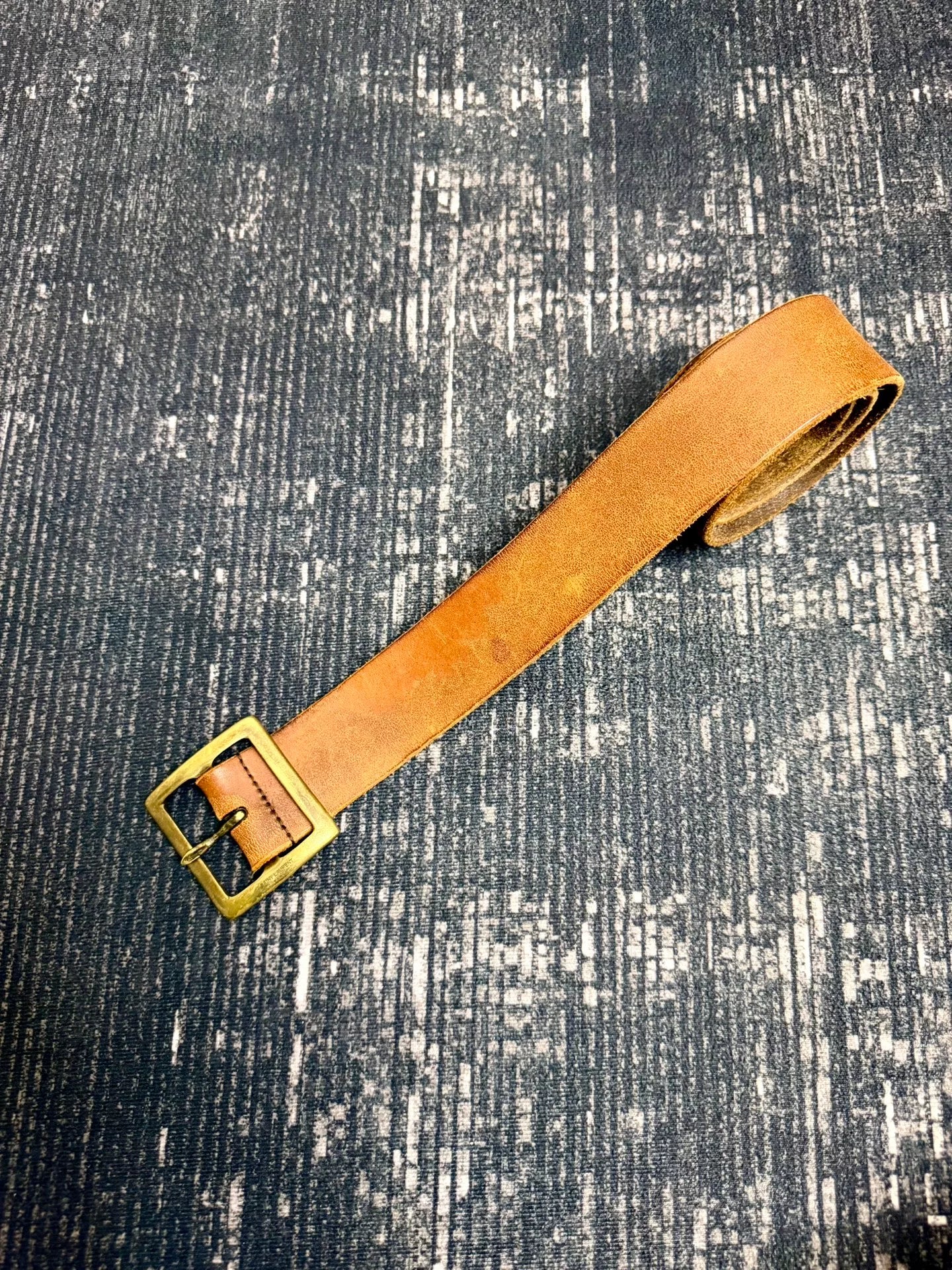brown leather belt with gold buckle