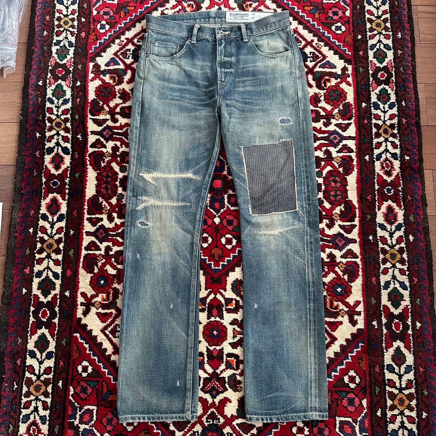 distressed blue jeans with unique detailing