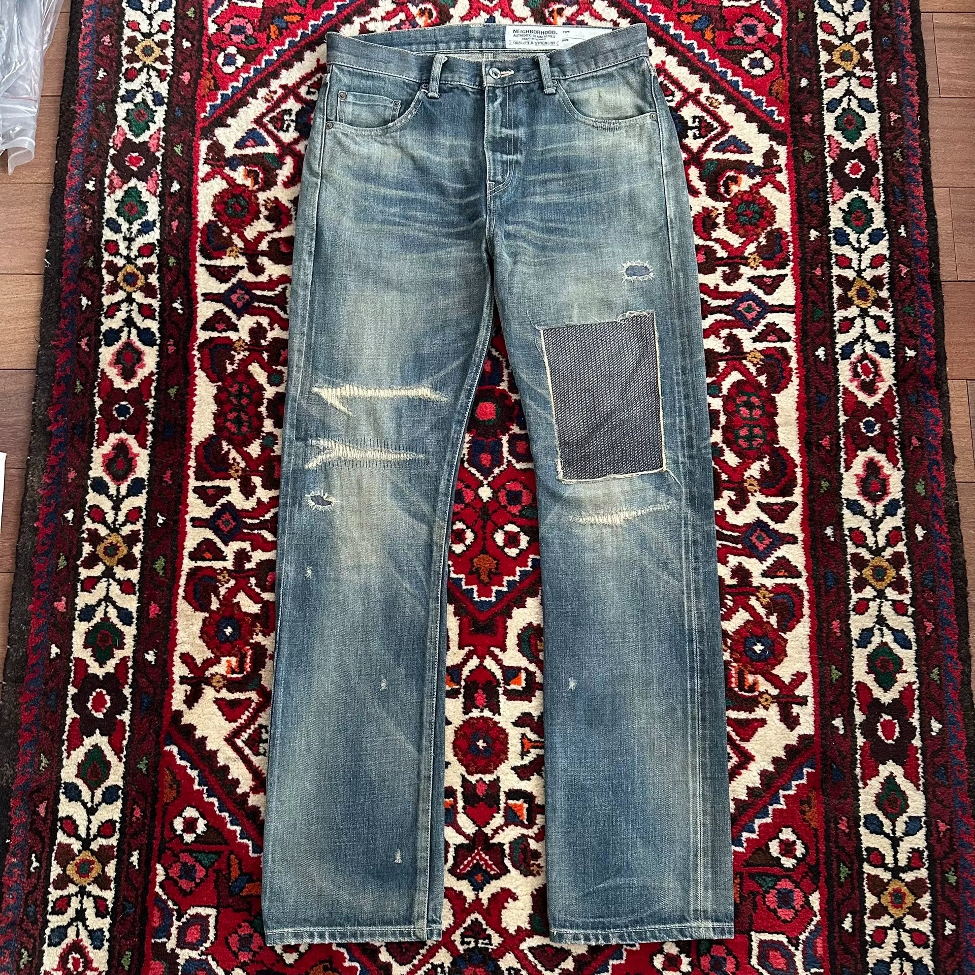 distressed blue jeans with unique detailing