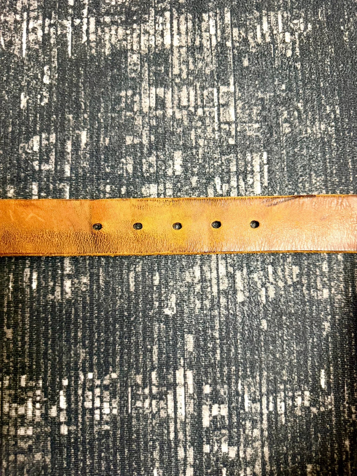 brown leather belt with gold buckle