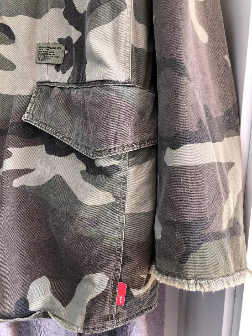camo jacket with unique distressed details