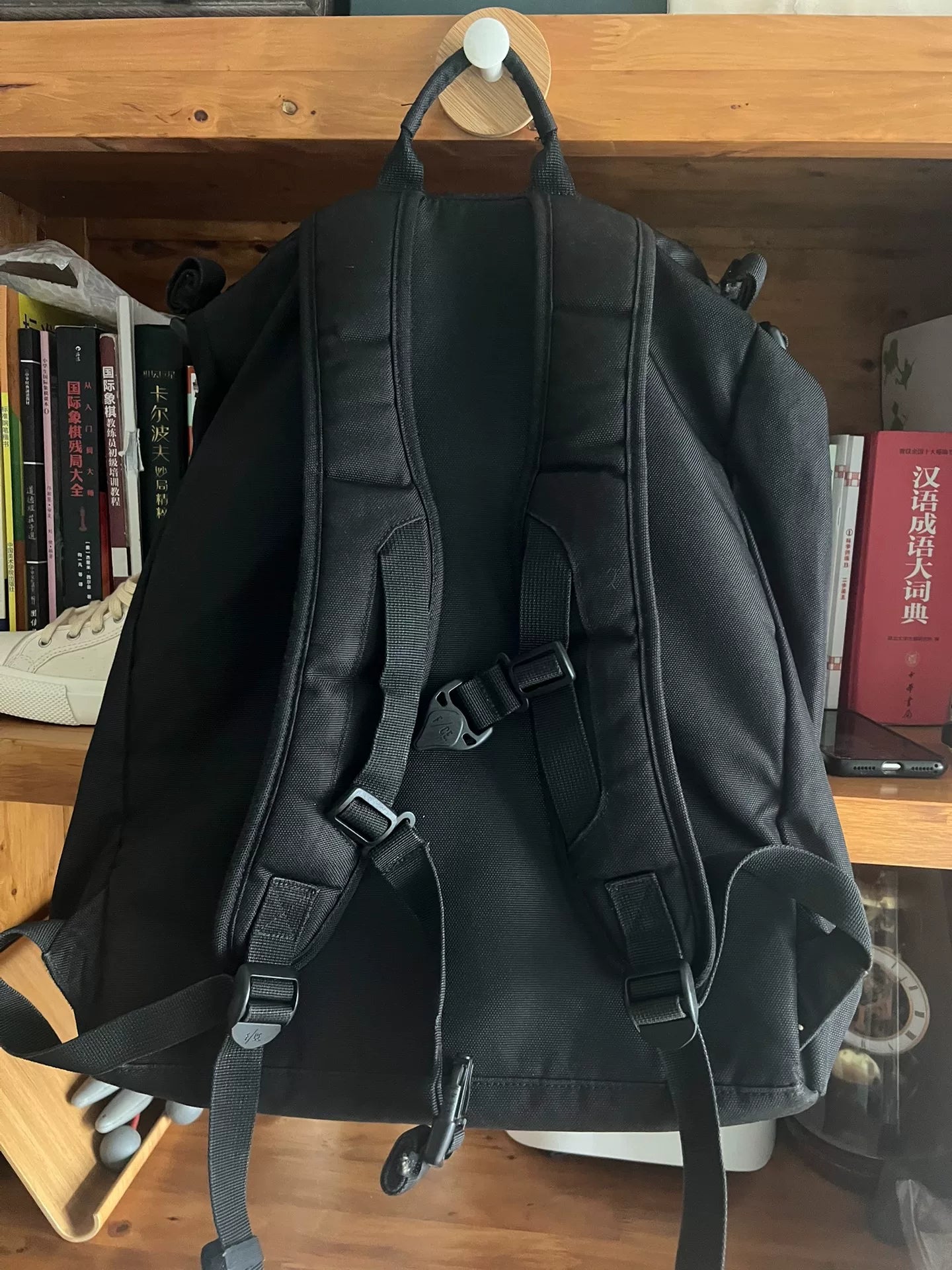 black roll-top backpack with multifunctional pockets