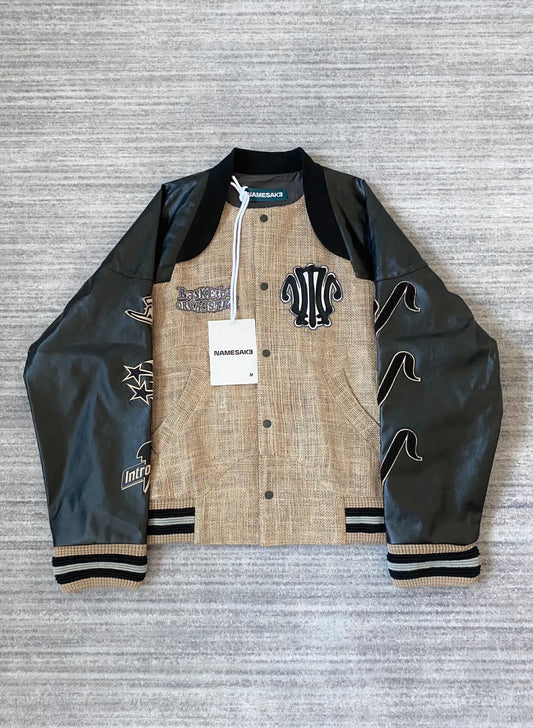 beige baseball jacket with leather sleeves