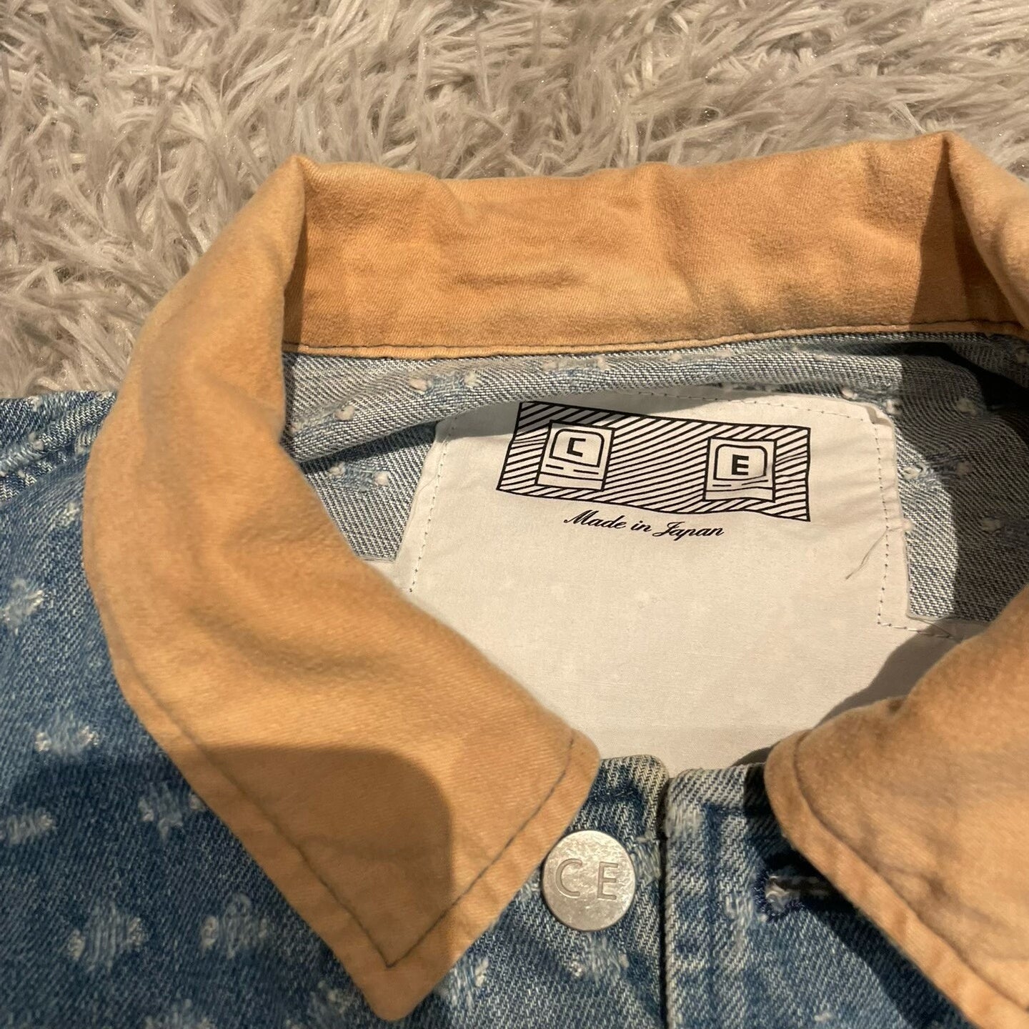 CE/CAVEMPT Distressed Denim Jacket