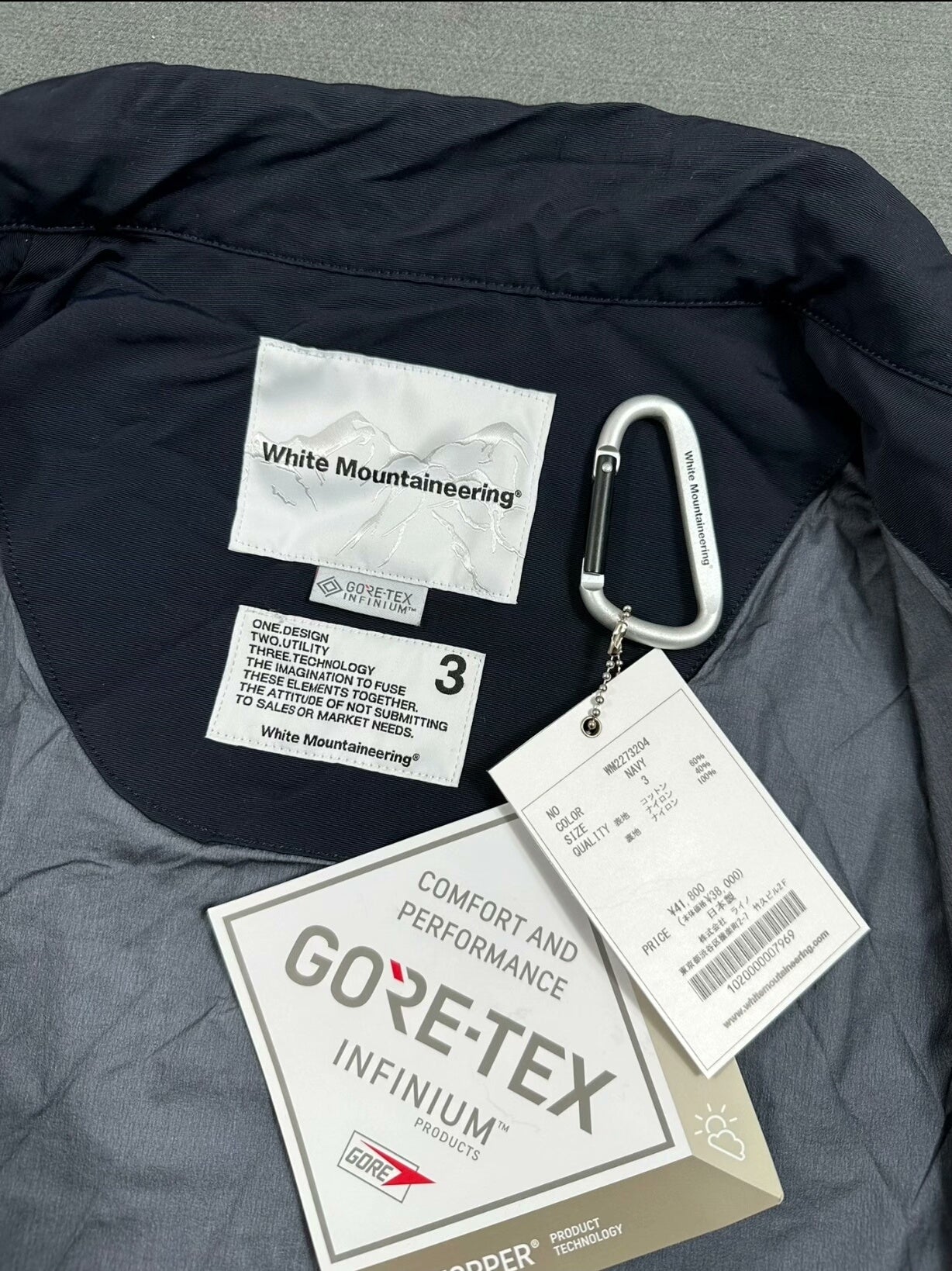 white mountaineering gore-tex coach jacket