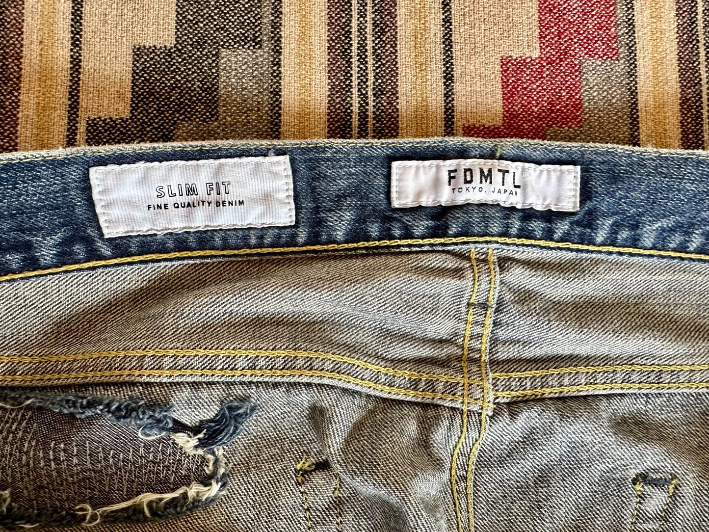 fdmtl slim fit distressed denim pants