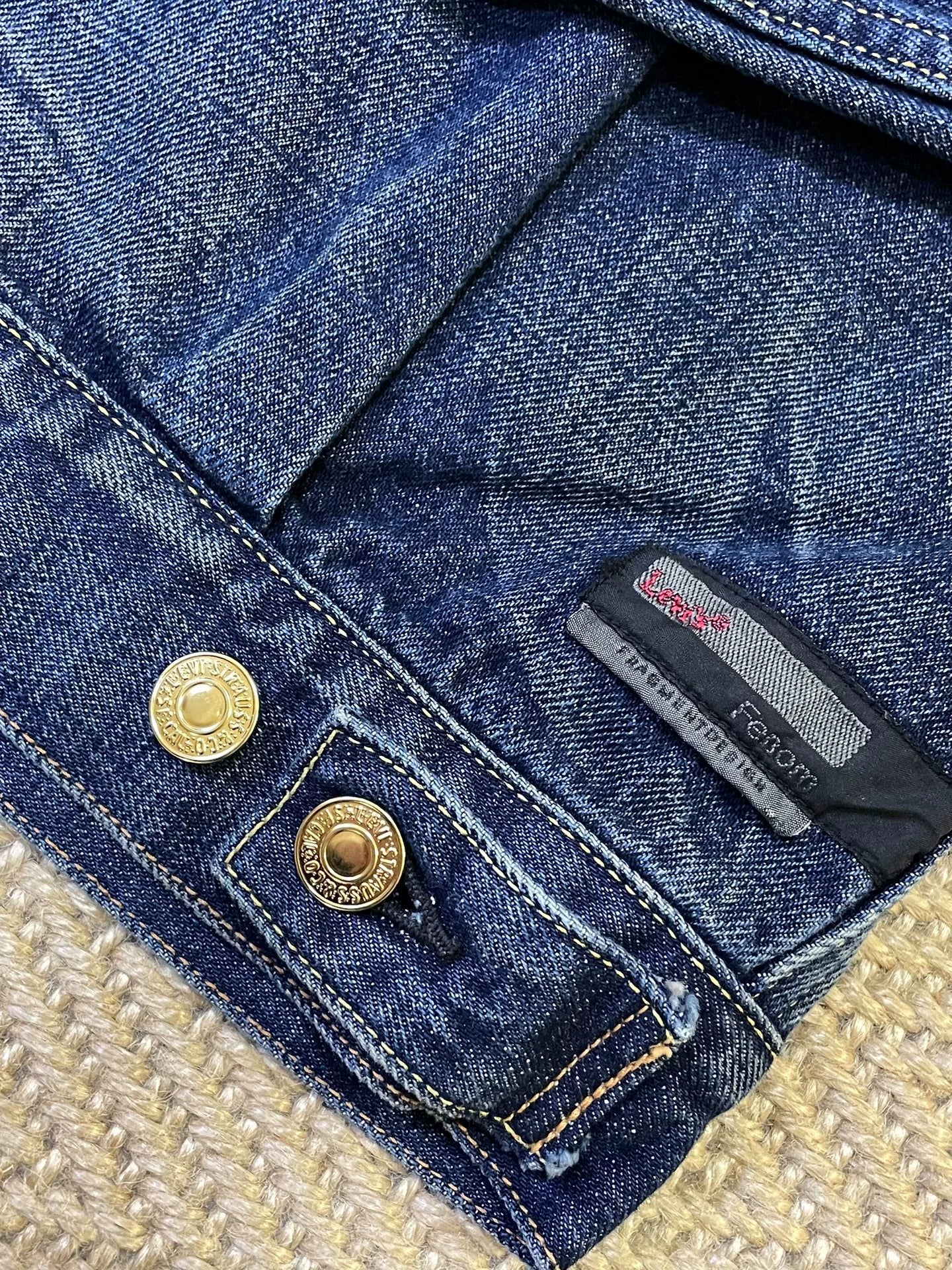 stylish blue denim jacket with gold buttons