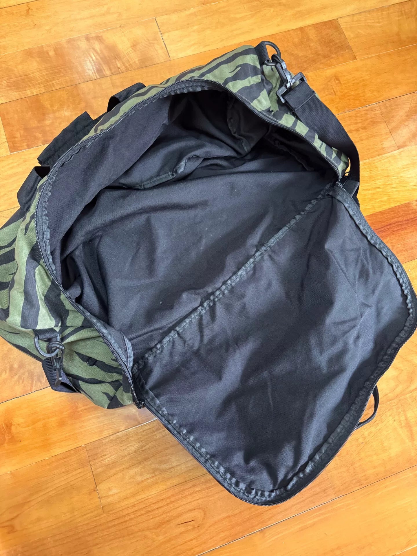 supreme camouflage duffle bag with red tag