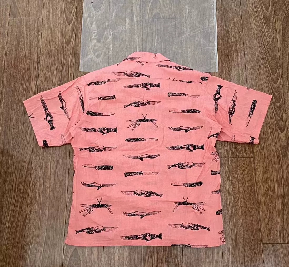 pink short sleeve shirt with fish print