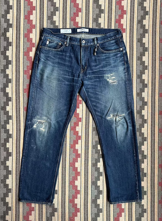 fdmtl slim fit denim with repair patches