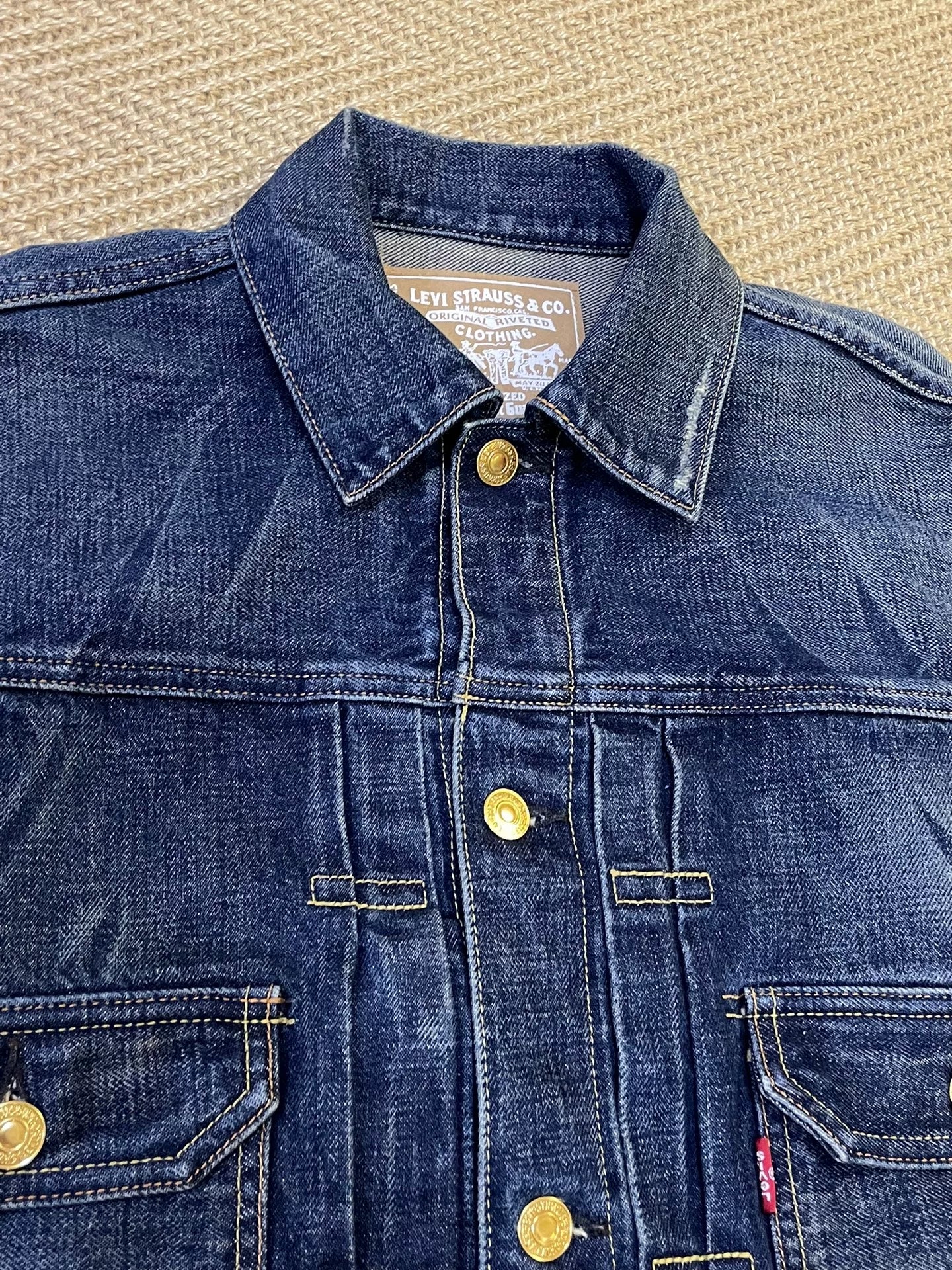 stylish blue denim jacket with gold buttons