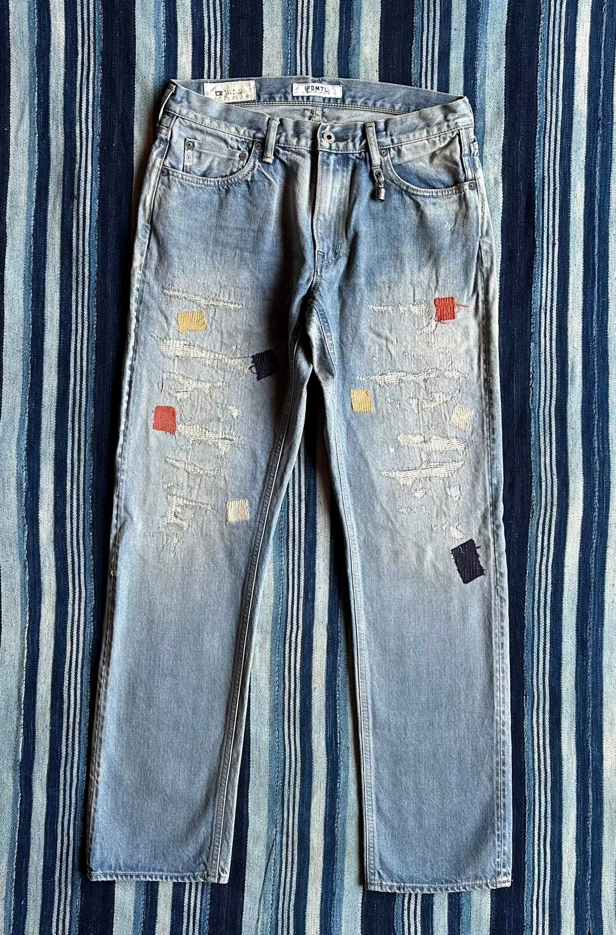 fdmtl slim fit denim distressed patchwork jeans