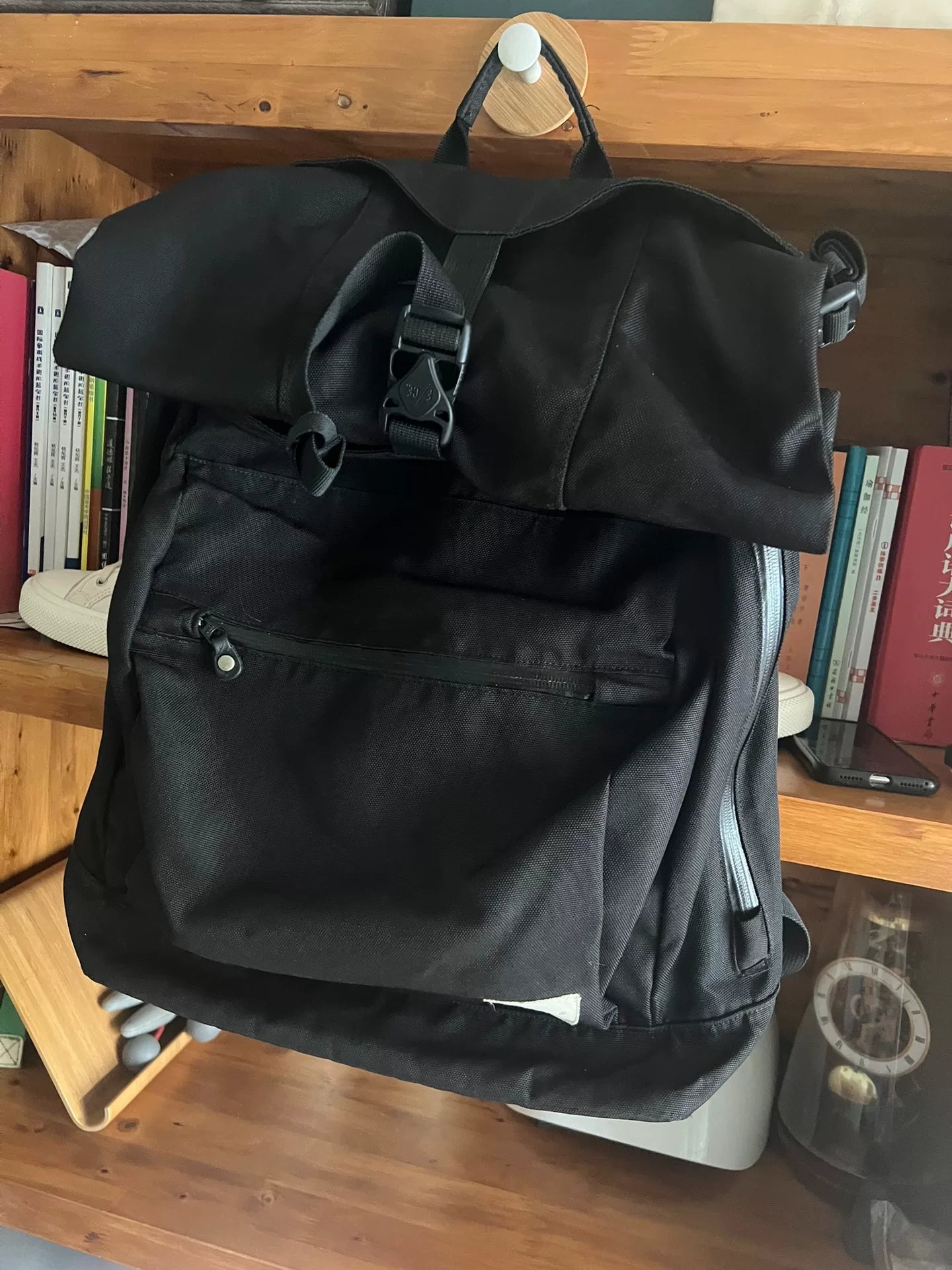 black roll-top backpack with multifunctional pockets