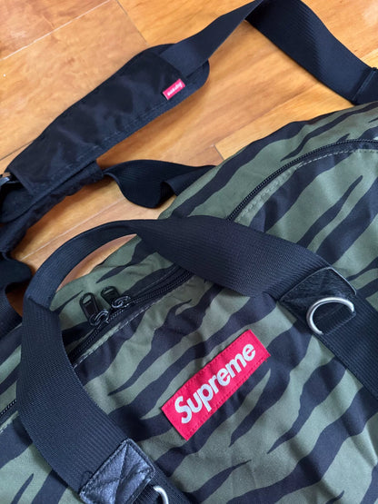 supreme camouflage duffle bag with red tag