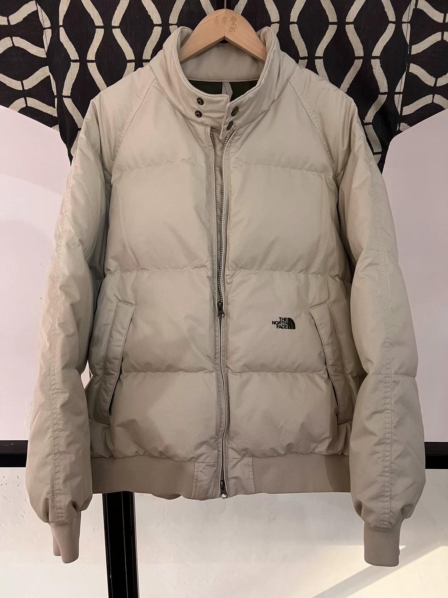 beige north face down jacket