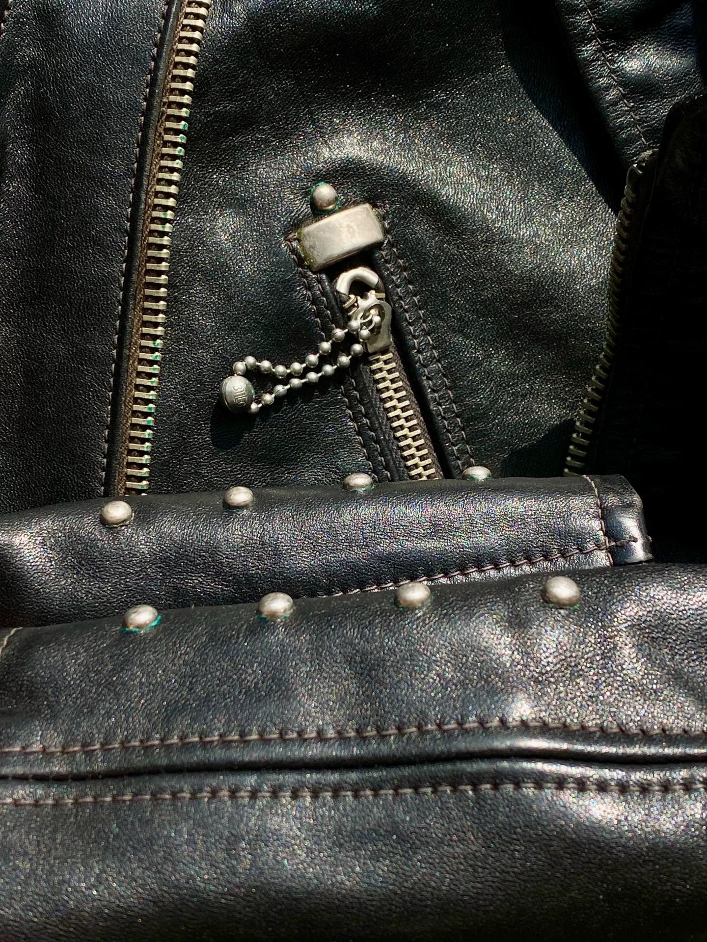 black leather biker jacket with detailed embellishments