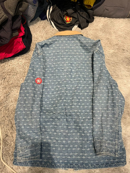 CE/CAVEMPT Distressed Denim Jacket