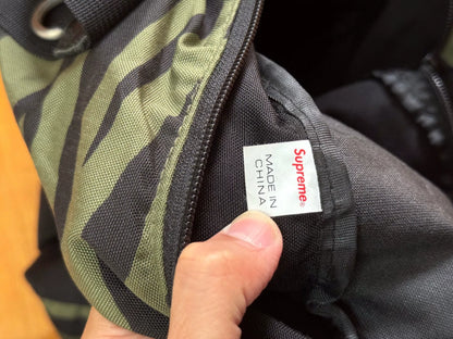 supreme camouflage duffle bag with red tag