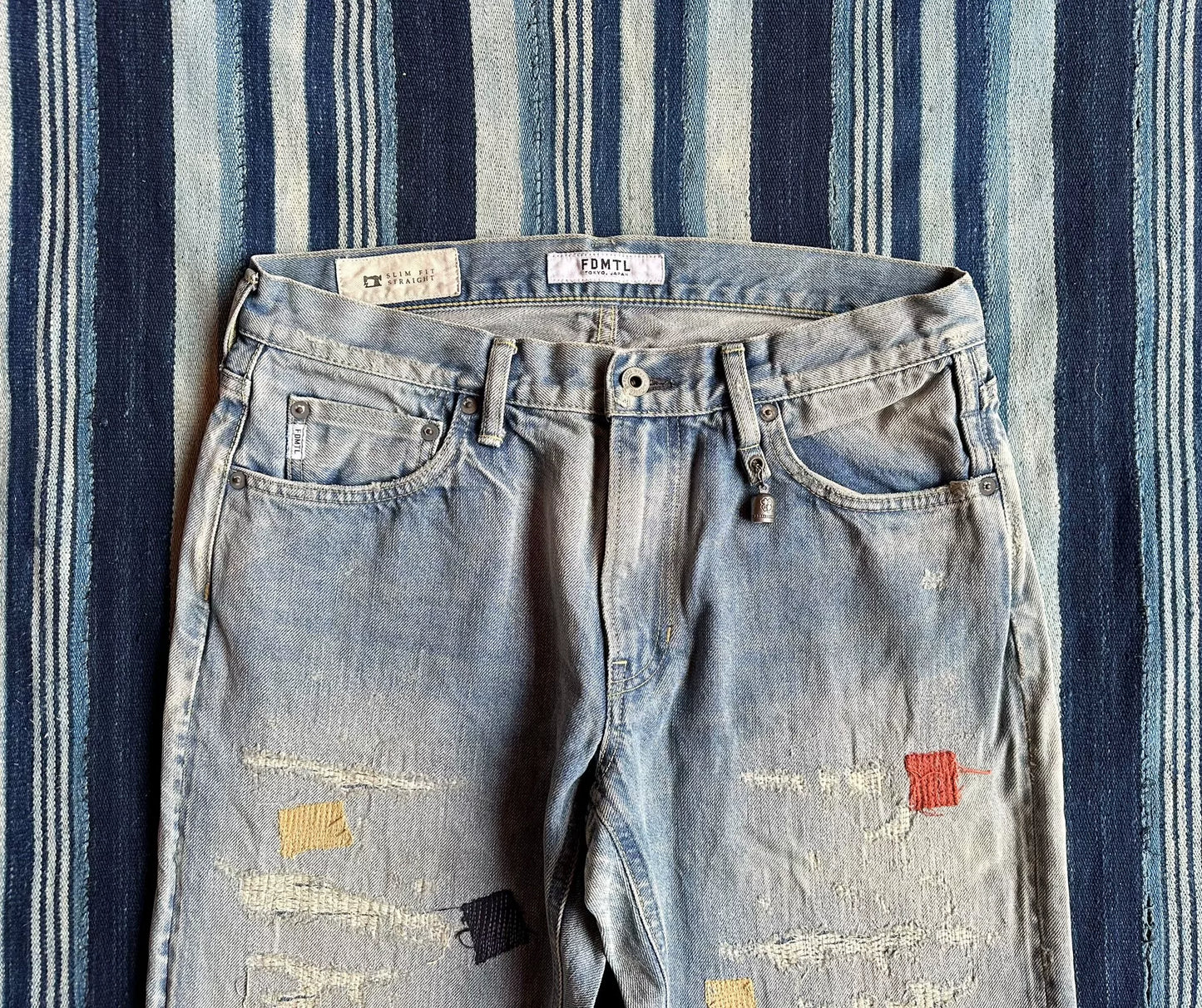 fdmtl slim fit denim distressed patchwork jeans