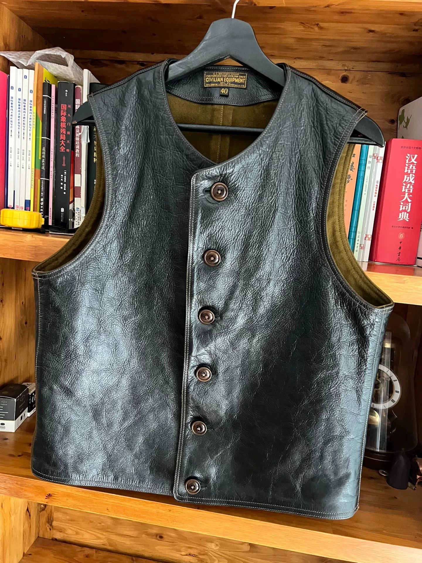 black leather vest with military green lining