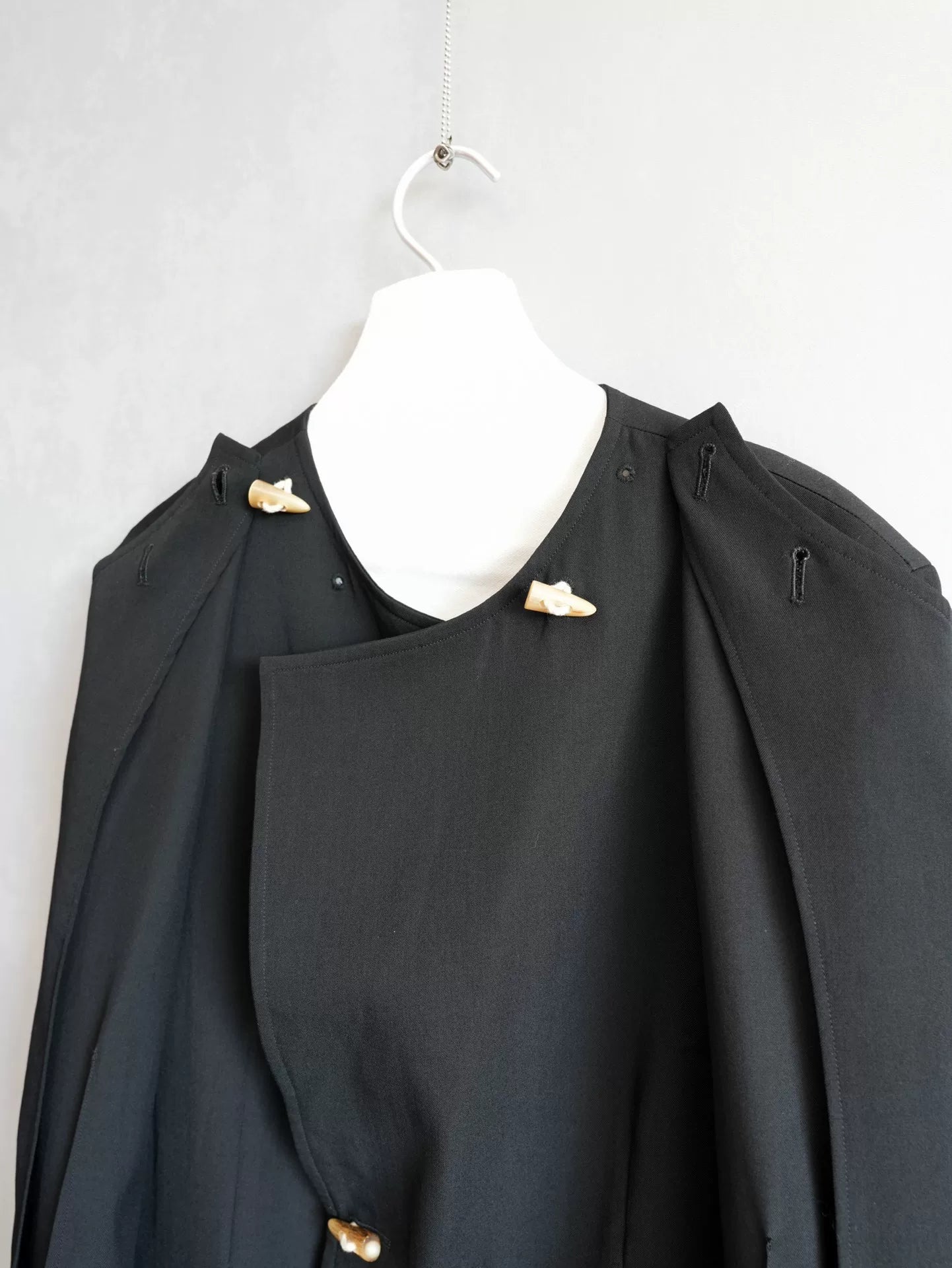 black double-breasted horn-button coat