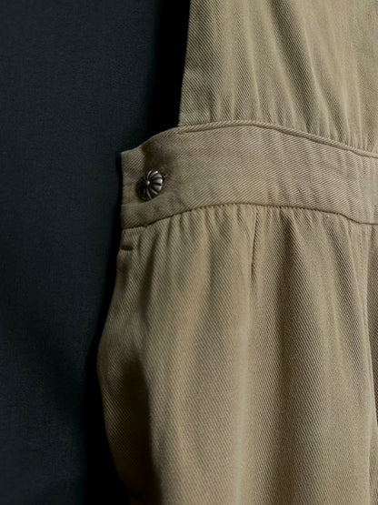 beige velvet overalls with silver buckles
