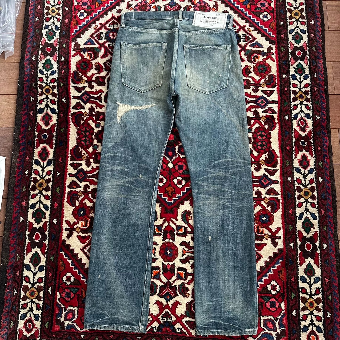 distressed blue jeans with unique detailing