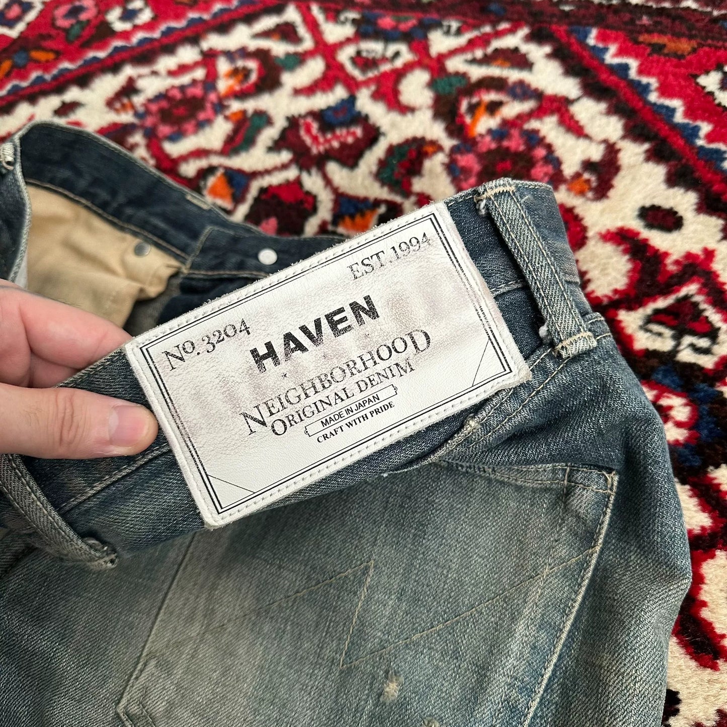 distressed blue jeans with unique detailing