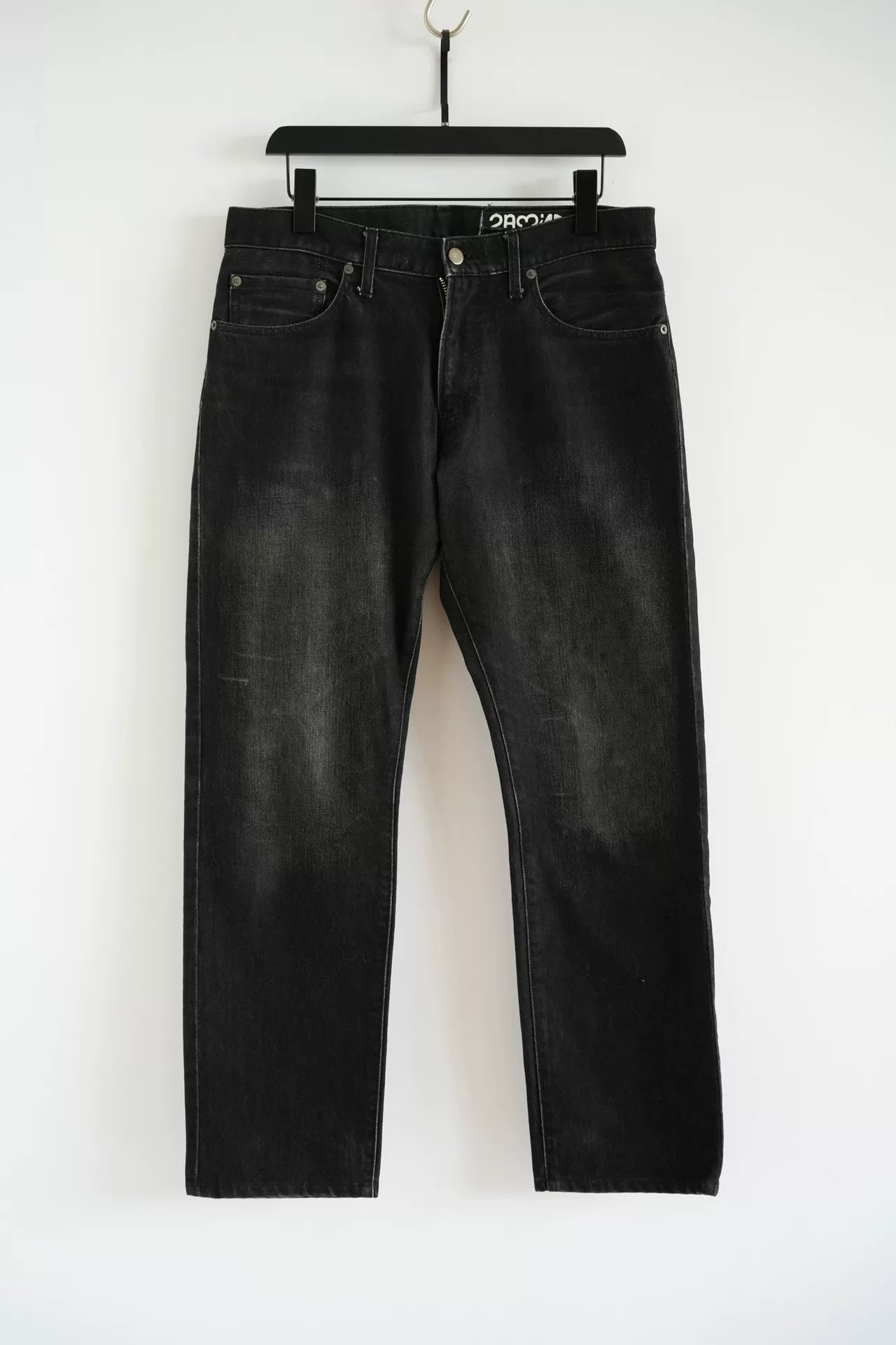 embroidered black denim pants by Undercover
