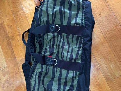 supreme camouflage duffle bag with red tag