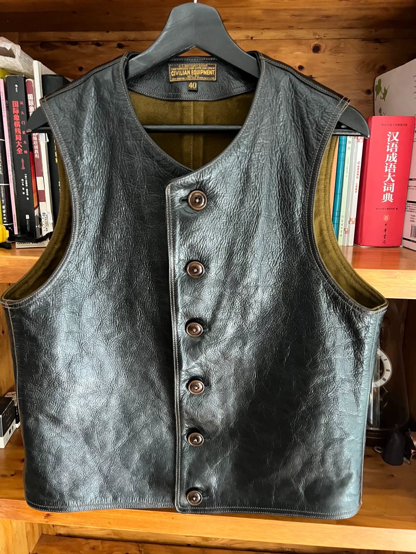 black leather vest with military green lining
