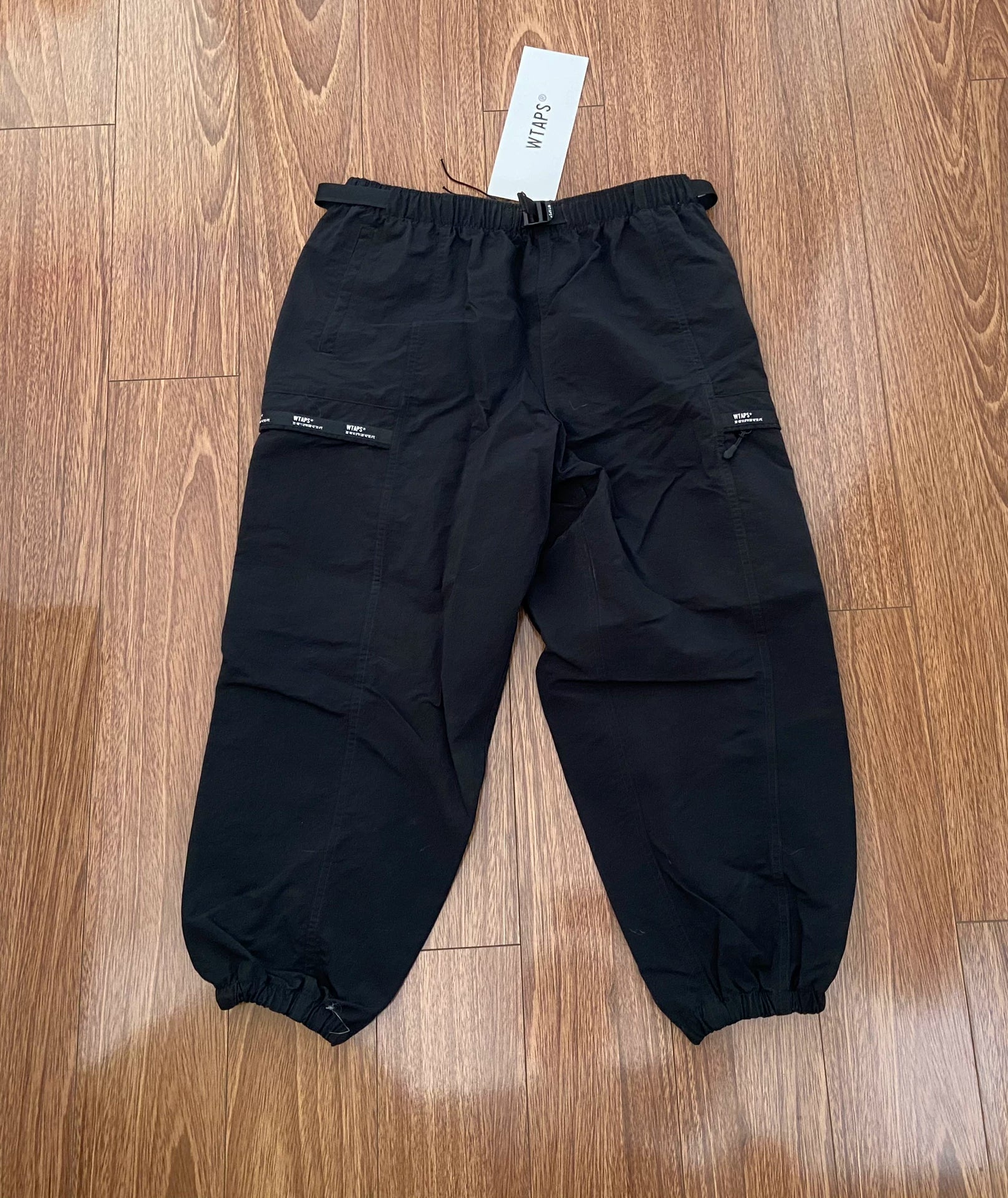 wtaps nylon track trousers in black
