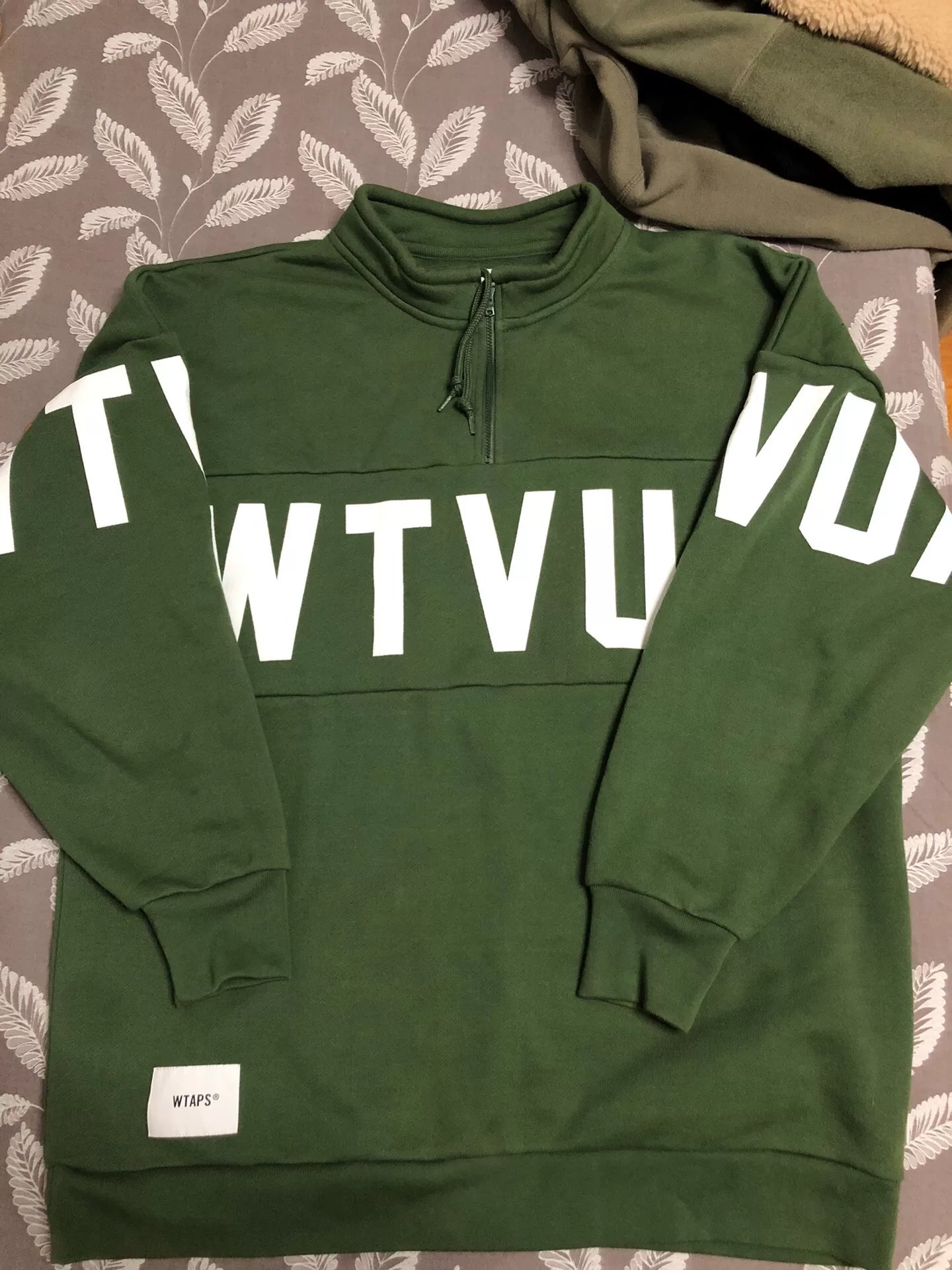wtaps green pullover sweatshirt with text