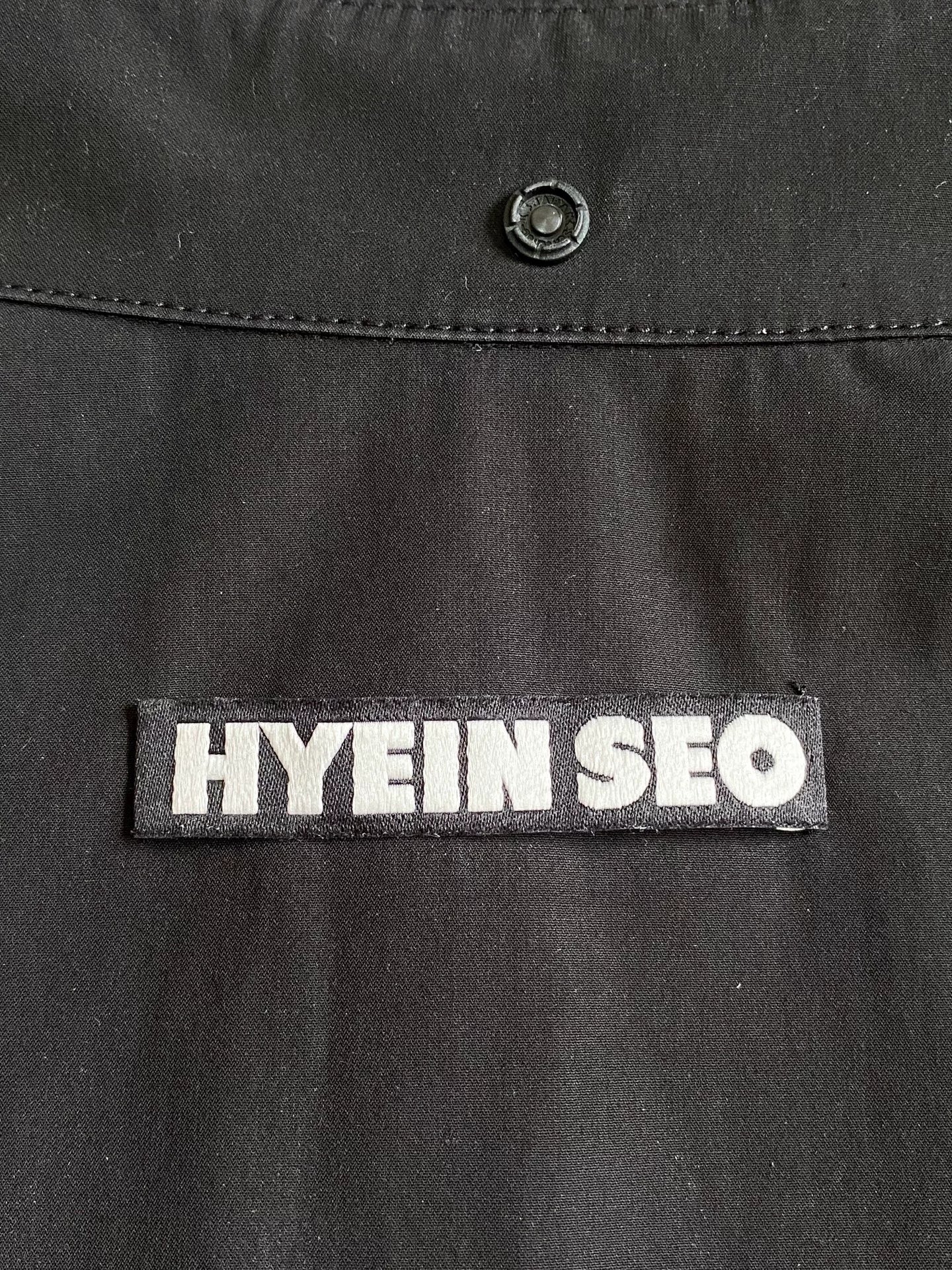 black pocket shirt with hidden buttons