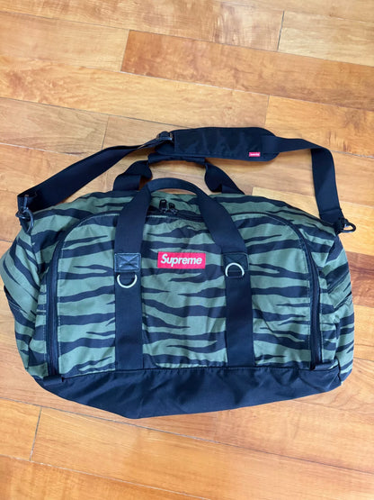 supreme camouflage duffle bag with red tag